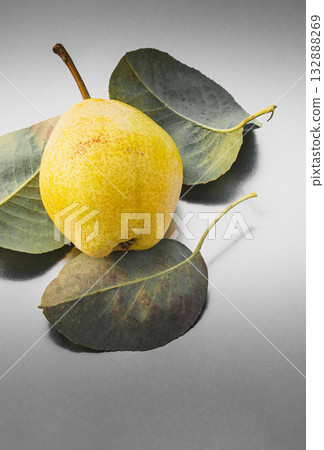 Pear and its leaves lie on an abstract surface, composite fashion photo 132888269