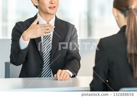 A young Asian businessman negotiating, serving and meeting with a female customer or businesswoman 132888658