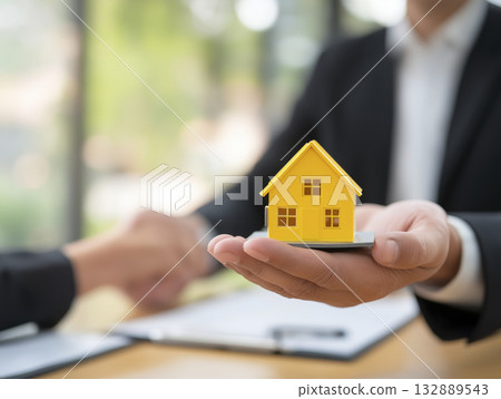 Real estate agent house model handshake contract sale keys real estate agent offers house model during handshake and contract 132889543