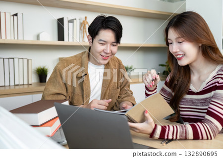 Back to School. Students sharing knowledge and resources in a bright study space. 132890695