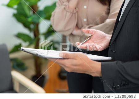 Real Estate Consultation. Professional agent discussing property details with client. Real Estate Consultation. Professional agent discussing property details with client. 132890698