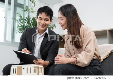 Real Estate Presentation. Agent explaining property details to client. 132890700