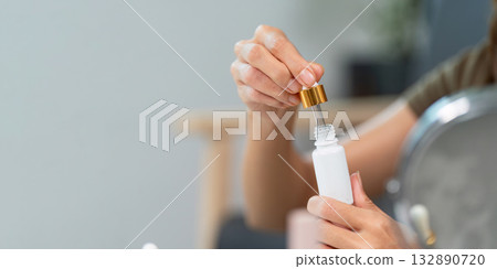 Skin Care Routine. Applying serum from a dropper bottle for healthy skin. Skin Care Routine. Applying serum from a dropper bottle for healthy skin. 132890720