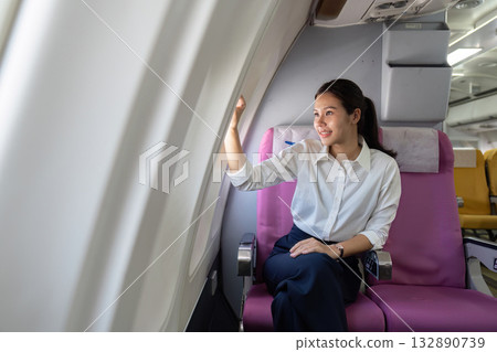 Travel Experience. Young woman enjoying window view on airplane. Travel Experience. Young woman enjoying window view on airplane. 132890739
