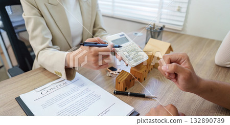 Real Estate Agent Consulting Client with Contract and Calculator 132890789