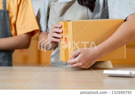 Small Business Logistics. Employee handling packages for shipping. Small Business Logistics. Employee handling packages for shipping. 132890795