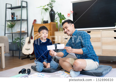Back to School Learning. Father and son engaging in educational activities at home. 132890810
