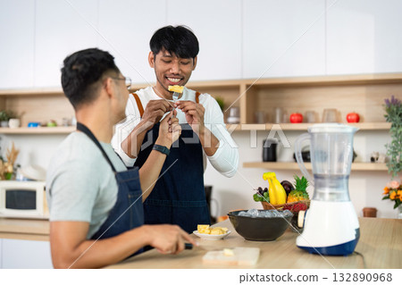 LGBT couple enjoying playful moments while cooking LGBT couple enjoying playful moments while cooking 132890968
