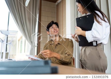 Engaging Discussion on ESG. Professionals strategizing in a modern office environment. 132891076