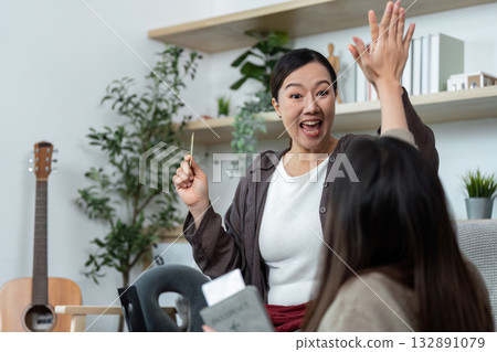 Travel Planning and Excitement. Woman joyfully discussing trip details with a friend. 132891079