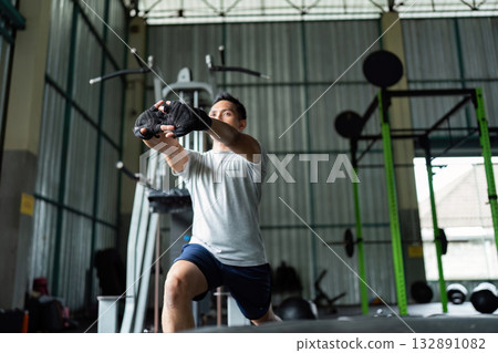 Functional Training. Man lunging with weights in gym. 132891082