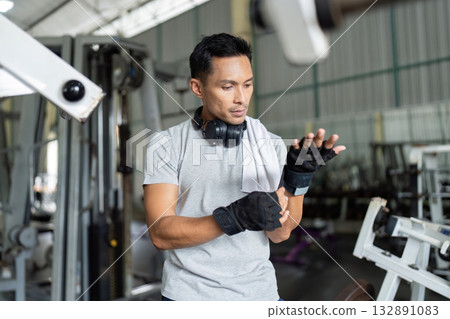 Gym Preparation. Man adjusting wrist wraps before workout. 132891083