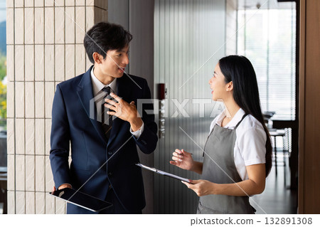 Business Communication. Two professionals discussing project details in a modern office. 132891308