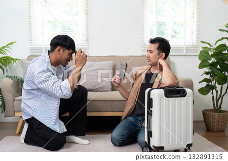 Planning and Travel. A couple discussing their travel plans while preparing for an exciting trip together. 132891315