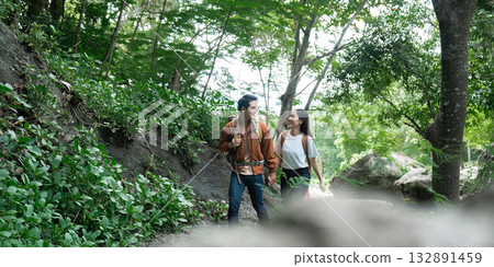 Couple walking hand in hand during a nature hike Couple walking hand in hand during a nature hike 132891459