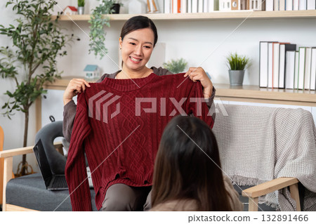 Mother and Daughter Choosing Clothes. Excitedly selecting outfits for their travel plans. Mother and Daughter Choosing Clothes. Excitedly selecting outfits for their travel plans. 132891466