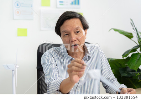 ESG Strategy Meeting. Senior professional explaining sustainable practices in business. ESG Strategy Meeting. Senior professional explaining sustainable practices in business. 132891554