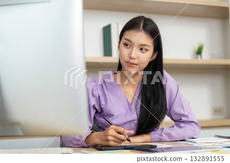 Graphic Design Professional Working on Digital Tablet and Computer 132891555
