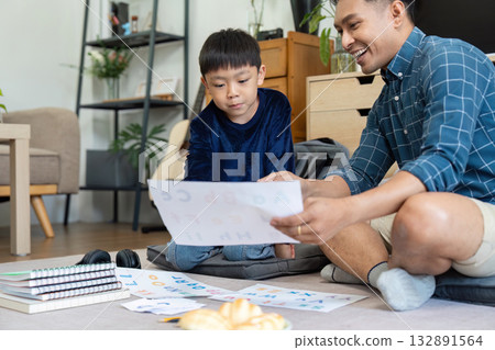 Father and Son Learning Together. Engaging in educational activities at home. Father and Son Learning Together. Engaging in educational activities at home. 132891564