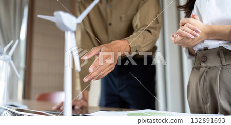 Sustainable Solutions Discussion. Professionals collaborating on renewable energy projects. 132891693