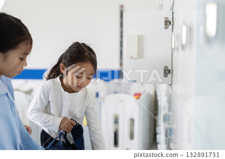 Back to School. Two Children Interacting at School Lockers 132891731