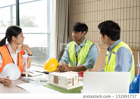 Sustainable Project Management. Engineers discussing renewable energy solutions in a modern workspace. Sustainable Project Management. Engineers discussing renewable energy solutions in a modern workspace. 132891737