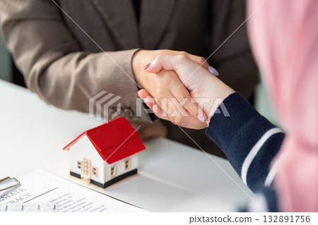 Real Estate Agreement. Two professionals shaking hands over a property deal. Real Estate Agreement. Two professionals shaking hands over a property deal. 132891756
