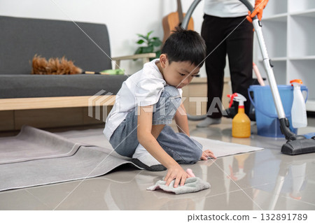 Cleaning and Learning. Young boy scrubbing floor with care at home. Cleaning and Learning. Young boy scrubbing floor with care at home. 132891789