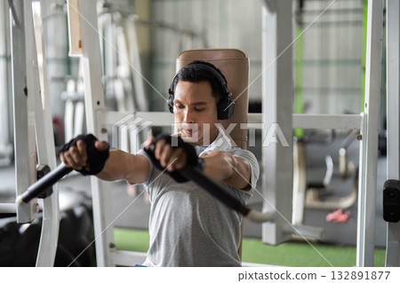 Fitness and Focus. Man engaging in chest press workout in gym. Fitness and Focus. Man engaging in chest press workout in gym. 132891877