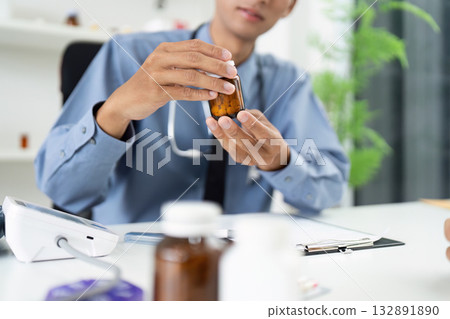 Healthcare Consultation. Doctor discussing medication with patient in modern office. 132891890