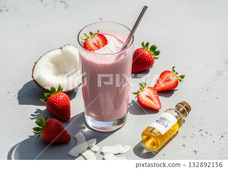Refreshing strawberry coconut smoothie with agave nectar and fresh fruit on a bright gray table. 132892156