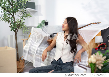 Moving Home. Woman enjoying a moment of relaxation in her new living space. 132892438