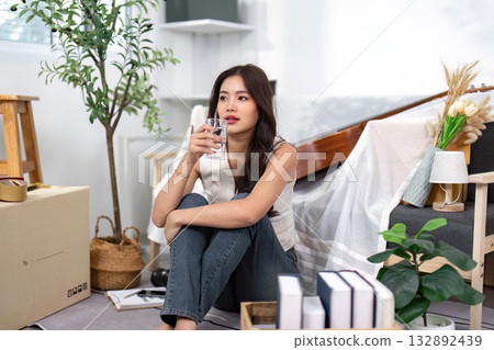 Home Moving: Woman Taking a Break with Water in New Space 132892439