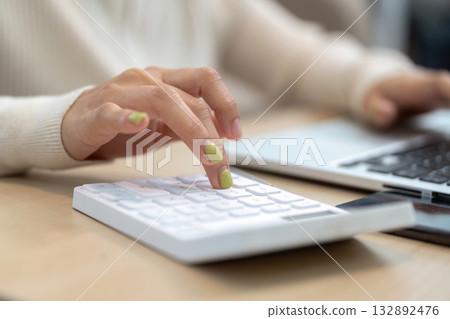 Financial Management Focus. Close-up of hands using calculator with laptop. 132892476