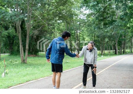 Father and Son Hydrating After Workout. Promoting wellness and healthy habits. Father and Son Hydrating After Workout. Promoting wellness and healthy habits. 132892527