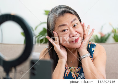 Beauty Expression and Self-Care. A woman playfully showing her skincare routine with a smile. Beauty Expression and Self-Care. A woman playfully showing her skincare routine with a smile. 132892546