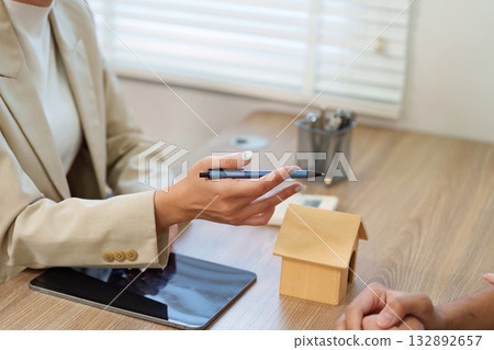 Real Estate Agent Explaining Property Details to Client Real Estate Agent Explaining Property Details to Client 132892657