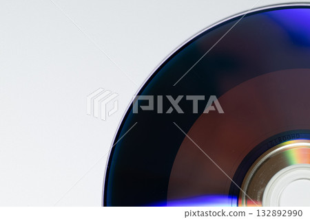Shiny reflection of a CD on a white background Shiny reflection of a CD on a white background 132892990