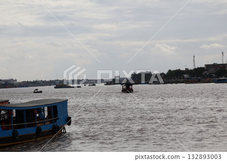 View of the boat, city and sky from a ferry on the Mekong River in Vietnam 132893003