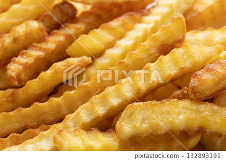Heap Of Crinkle Cut French Fries. Close-up Heap Of Crinkle Cut French Fries. Close-up 132893191