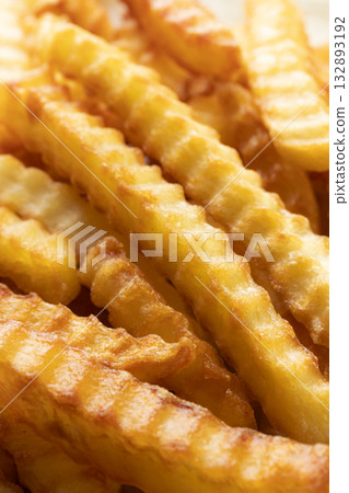 Heap Of Crinkle Cut French Fries. Close-up Heap Of Crinkle Cut French Fries. Close-up 132893192