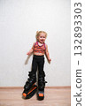 The child is standing in a sports uniform and in Stylish kangoo shoes 132893303