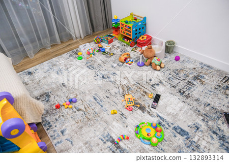 Different colored bright toys in the room where the child is playing Different colored bright toys in the room where the child is playing 132893314