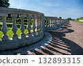 A long row of stone pillars with a shadow cast on the ground 132893315