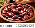 Raw red kidney beans in wooden bowl. Close-up 132893425