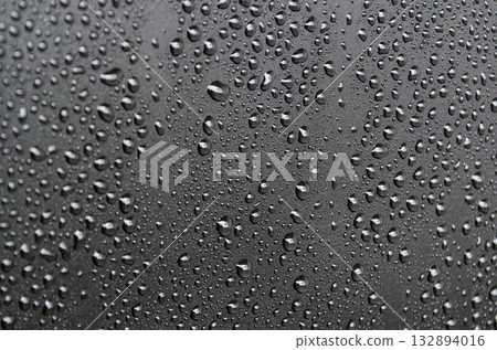 Close up view of water droplets on black cover background. Suitable for design and wallpaper. Close up view of water droplets on black cover background. Suitable for design and wallpaper. 132894016