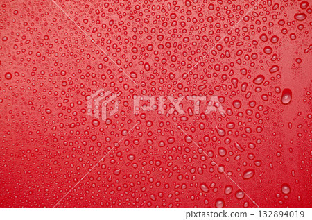 Water droplets on red cover background. Suitable for design and wallpaper. Water droplets on red cover background. Suitable for design and wallpaper. 132894019