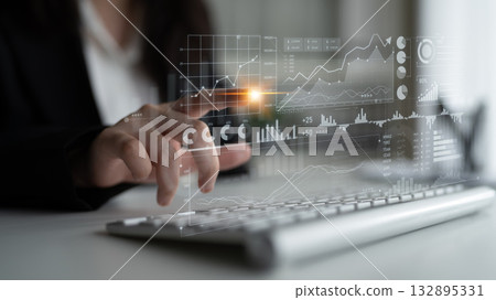 Business professional analyzing data trends on a digital screen while working on a laptop for financial decision making and strategic planning Scalp 132895331