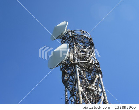 Parabolic antenna shining against the blue sky 132895900