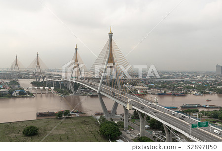 the Bhumibol Bridge, which is also known as the Industrial Ring Road Bridge. is a cable-stayed bridge that crosses the Chao Phraya River. the Bhumibol Bridge, which is also known as the Industrial Ring Road Bridge. is a cable-stayed bridge that crosses the Chao Phraya River. 132897050